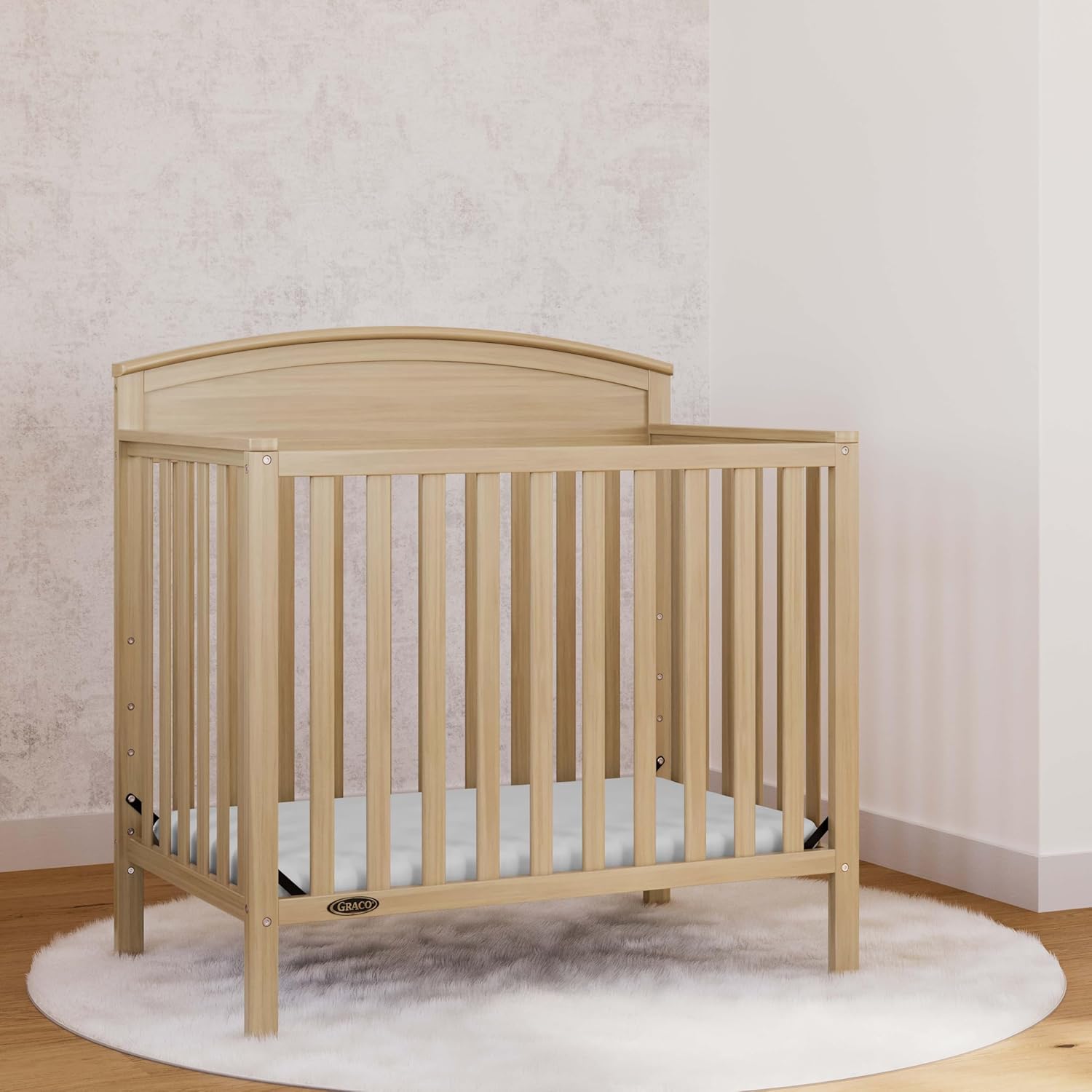 Graco Benton 4-in-1 Convertible Mini Crib with Bonus Crib Mattress – GREENGUARD Gold Certified, 2.75-Inch Mattress Included, Baby Crib Converts to Twin Bed, Ideal for Small Spaces (Driftwood)