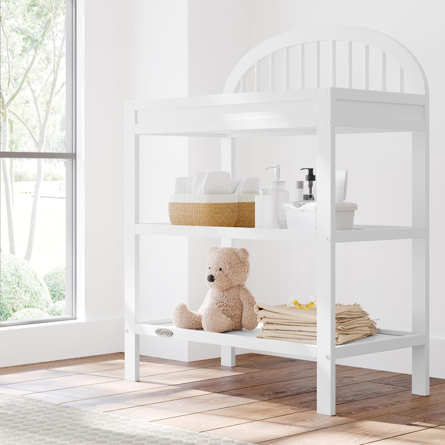 Graco Olivia Changing Table with Water-Resistant Changing Pad (White) - GREENGUARD Gold Certified, Includes Bonus Water-Resistant Changing Pad with Safety Strap, 2 Open Shelves, Stylish Design