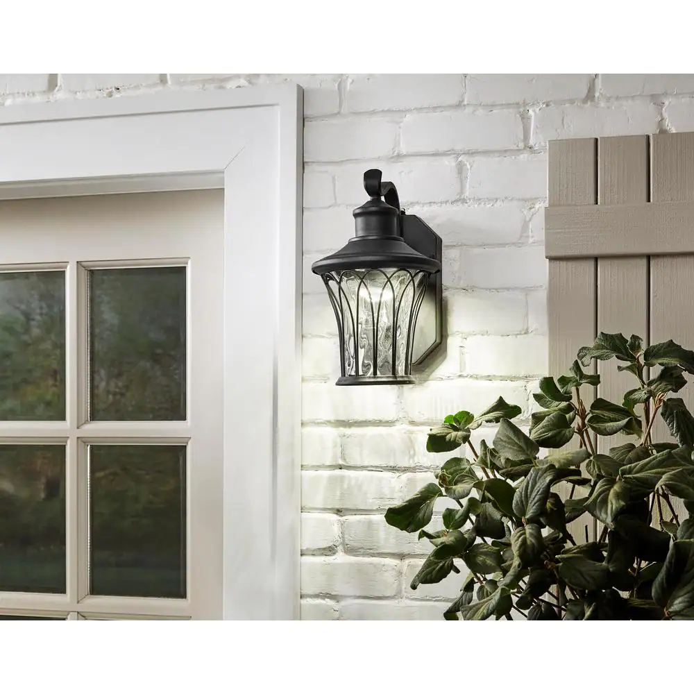 Home Decorators Collection Avia Falls Black Dusk to Dawn Small LED Outdoor Wall Light Fixture with Clear Water Glass