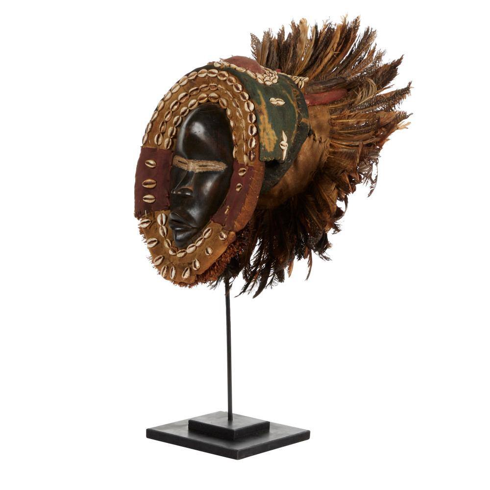 Litton Lane Large Hand-Carved Baobab Wood, Chicken Feathers and Cowrie Shell Dan Mask on Stand