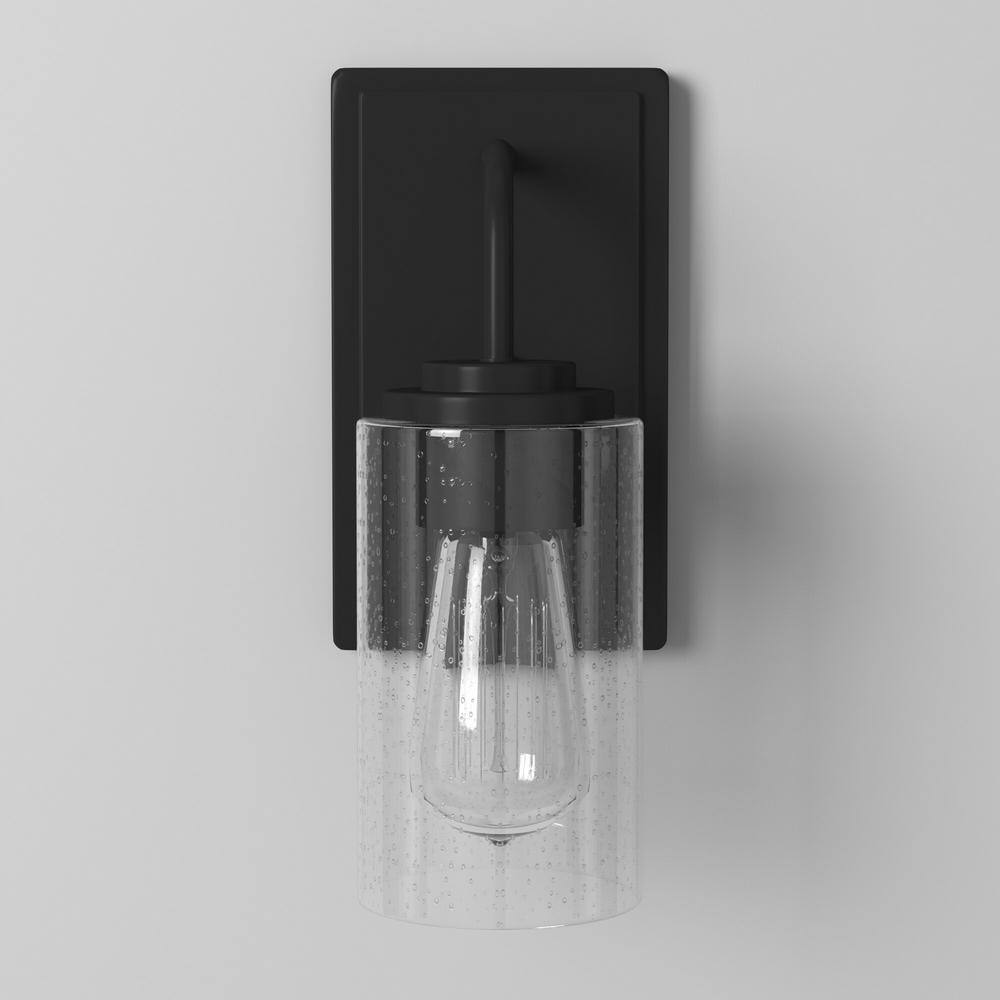 Designers Fountain Logan 4.5 in. 1-light Matte Black Transitional indoor wall sconce with Clear Seedy Glass Shade