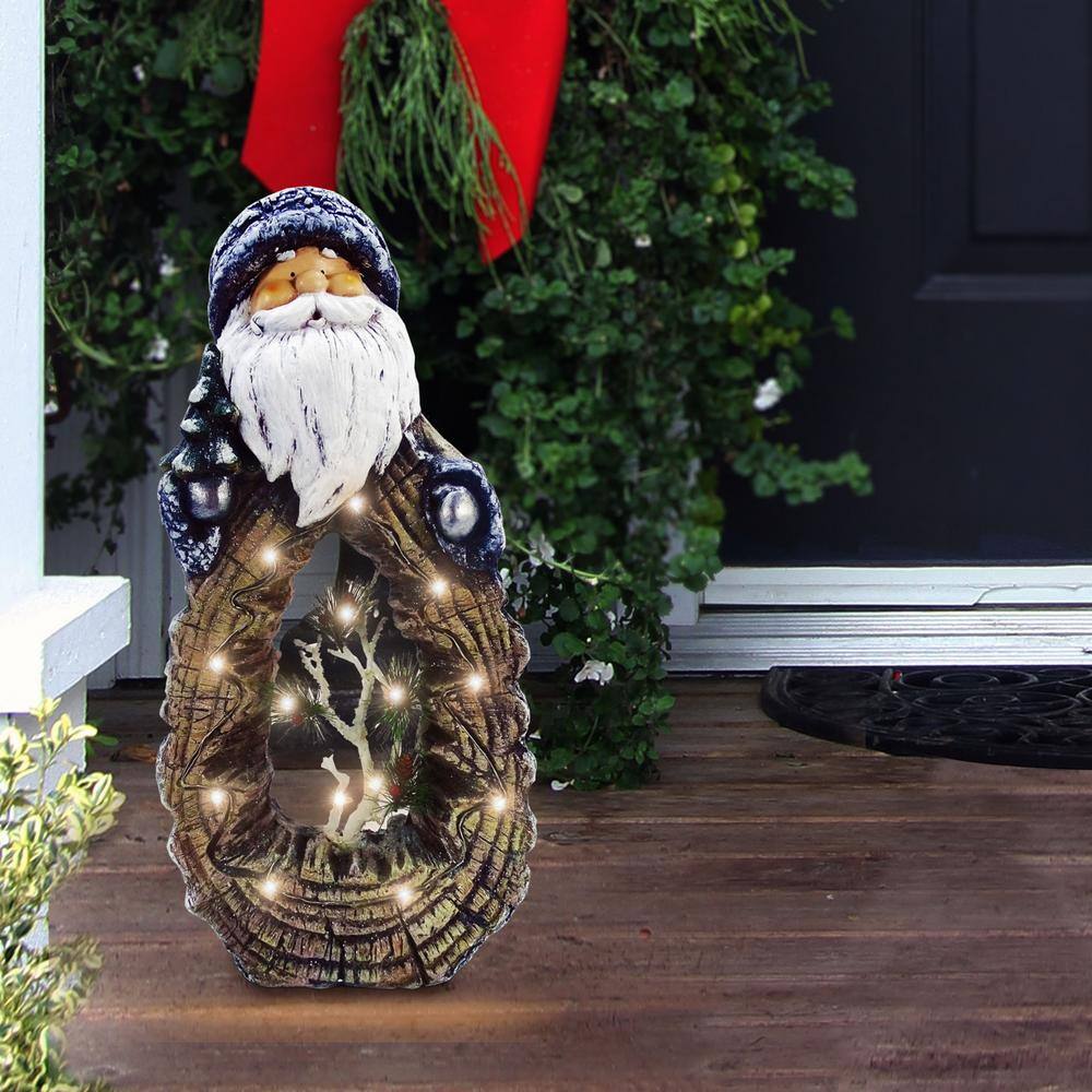 Alpine Corporation 21 in. Tall Santa Statue with Carved Wood Look and LED Lights
