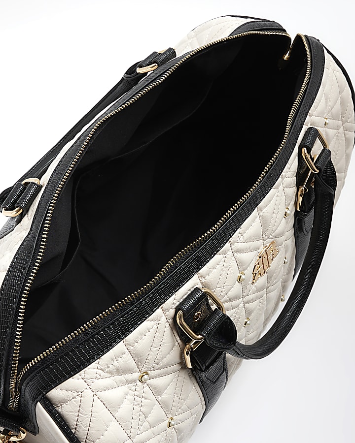 Cream quilted pearl travel bag