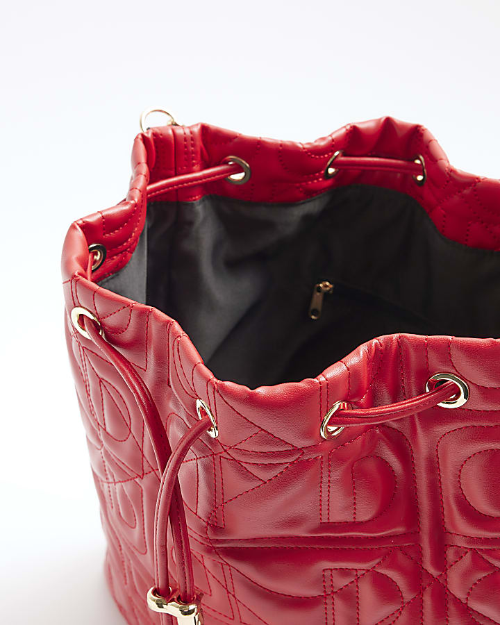 Red quilted drawstring shoulder bag