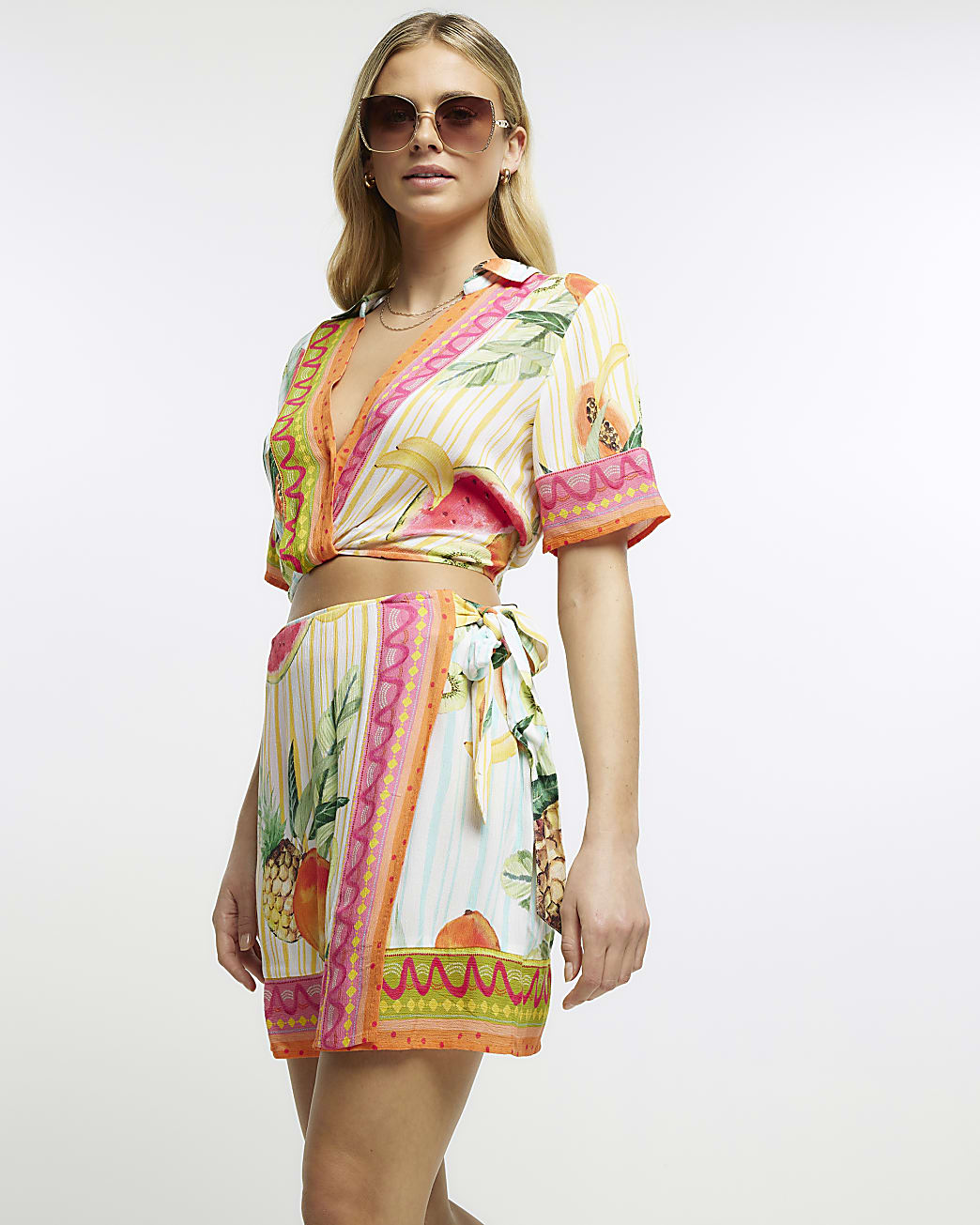 Yellow printed wrap over mini skirt