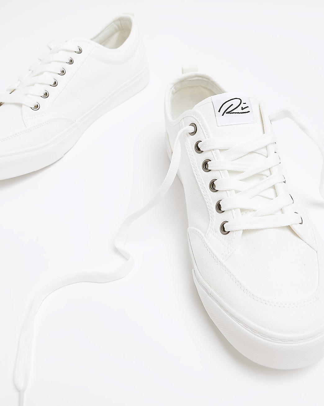 White canvas lace up trainers