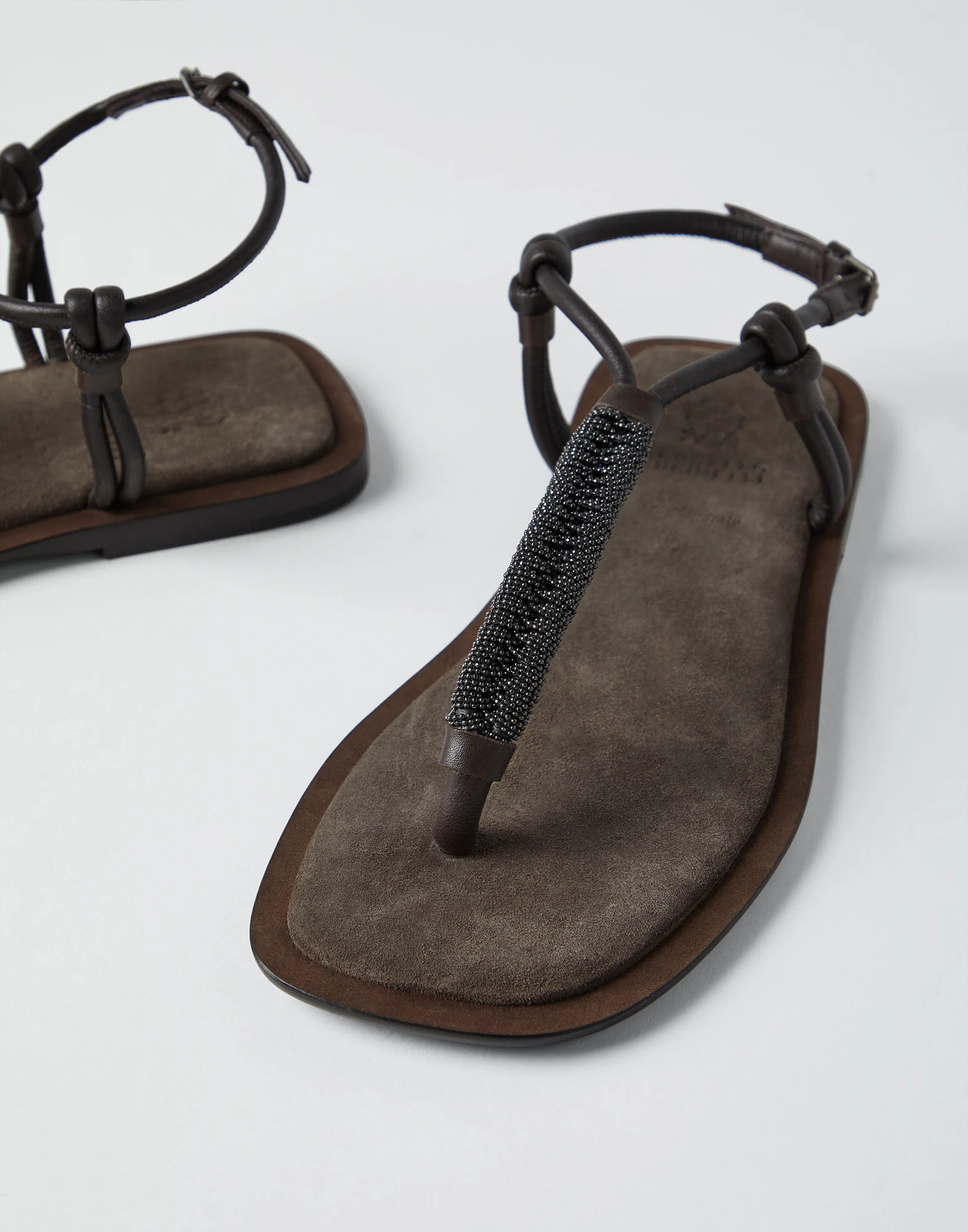 Suede sandals with precious braided straps