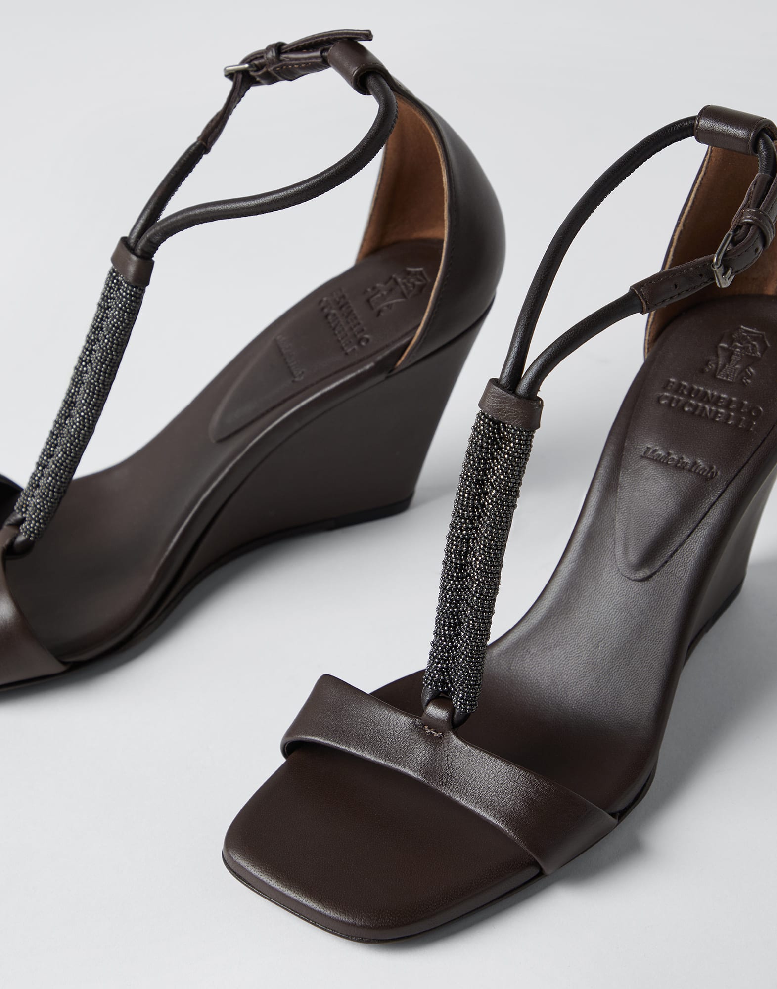 Nappa leather wedge sandals with precious braided strap