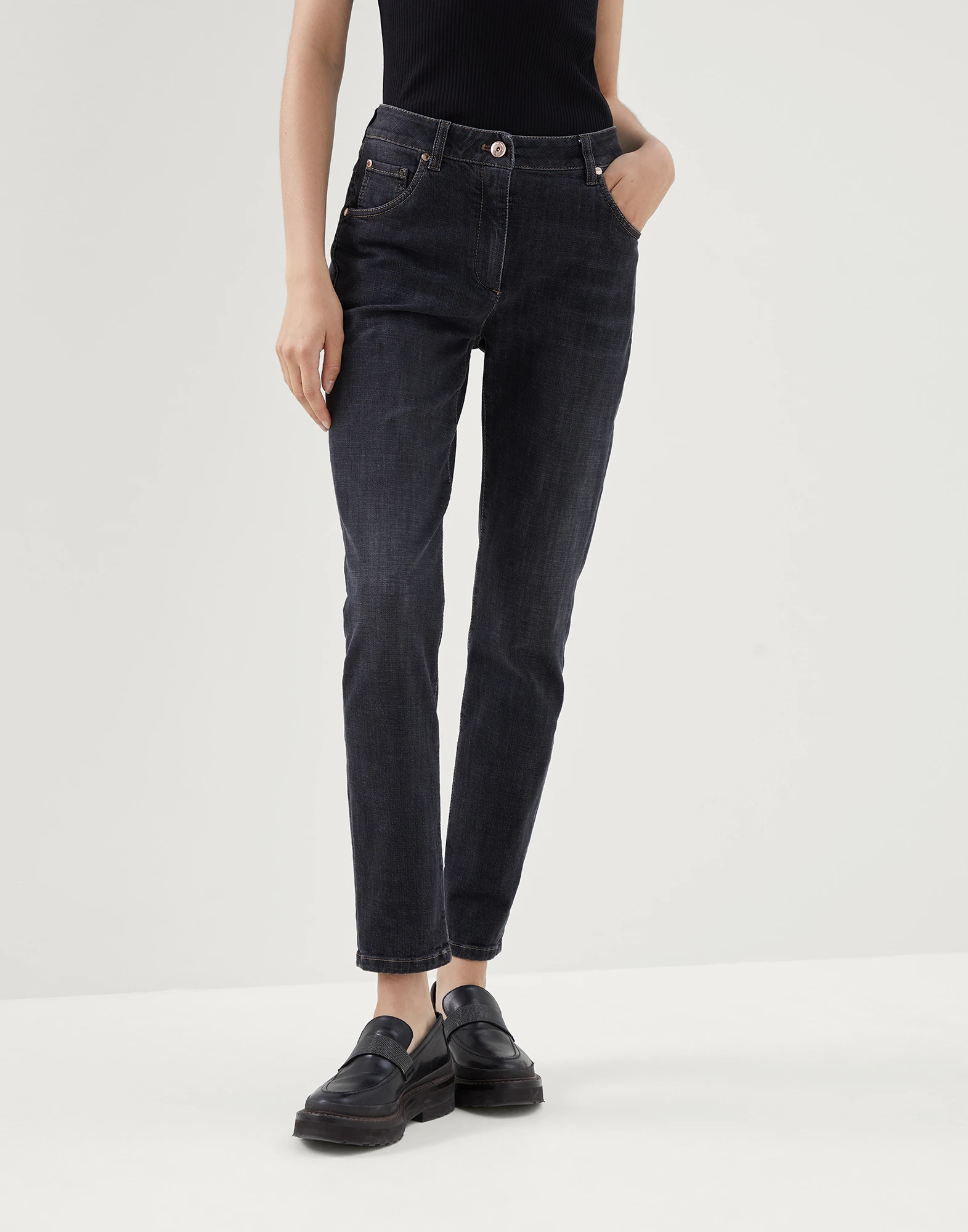 Stretch denim slim trousers with shiny leather tab