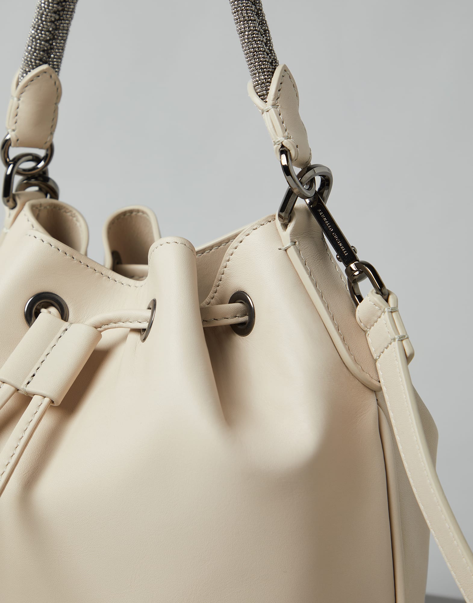 Calfskin bucket bag with precious braided handle