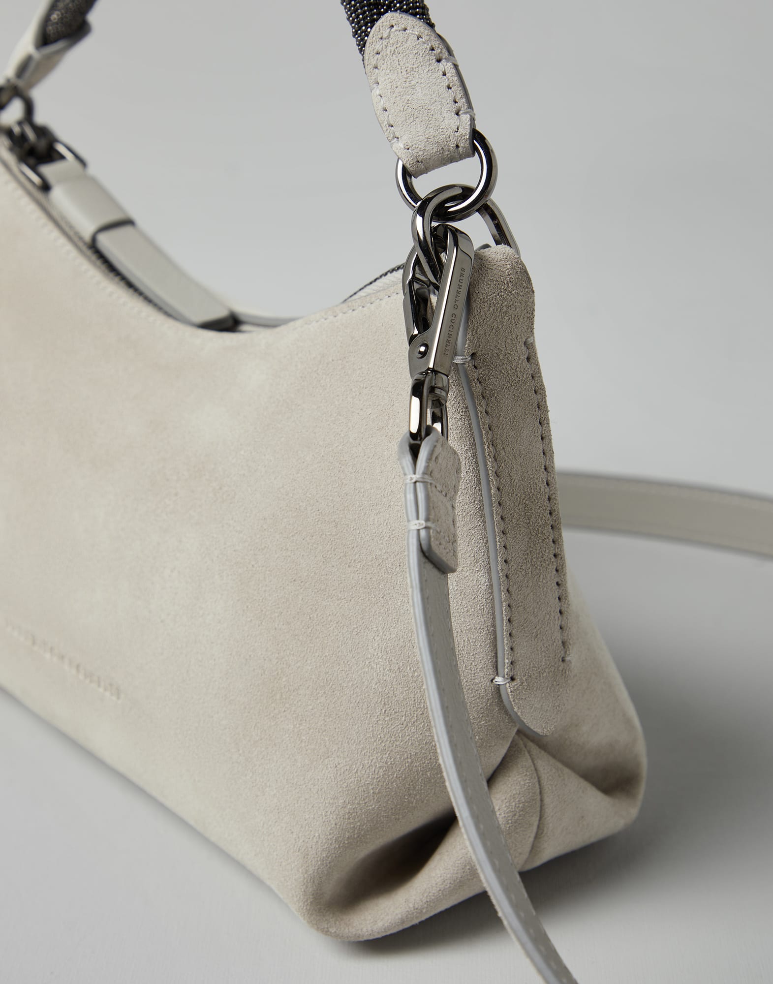 Suede bag with precious braided handle