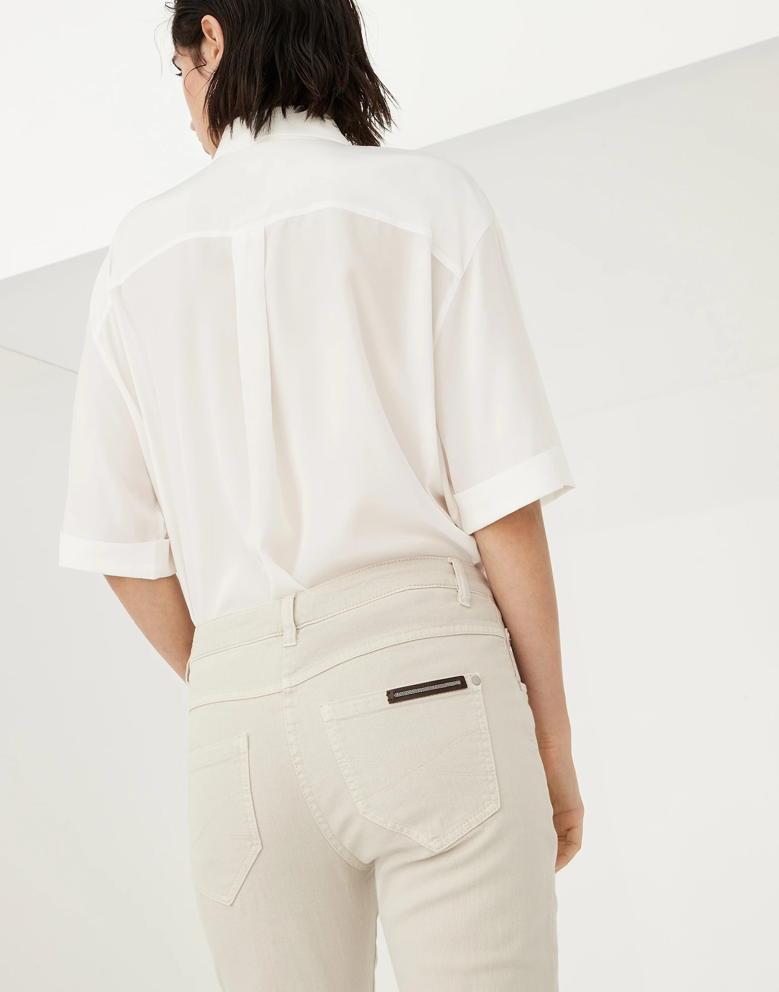 Stretch dyed denim slim trousers with shiny leather tab