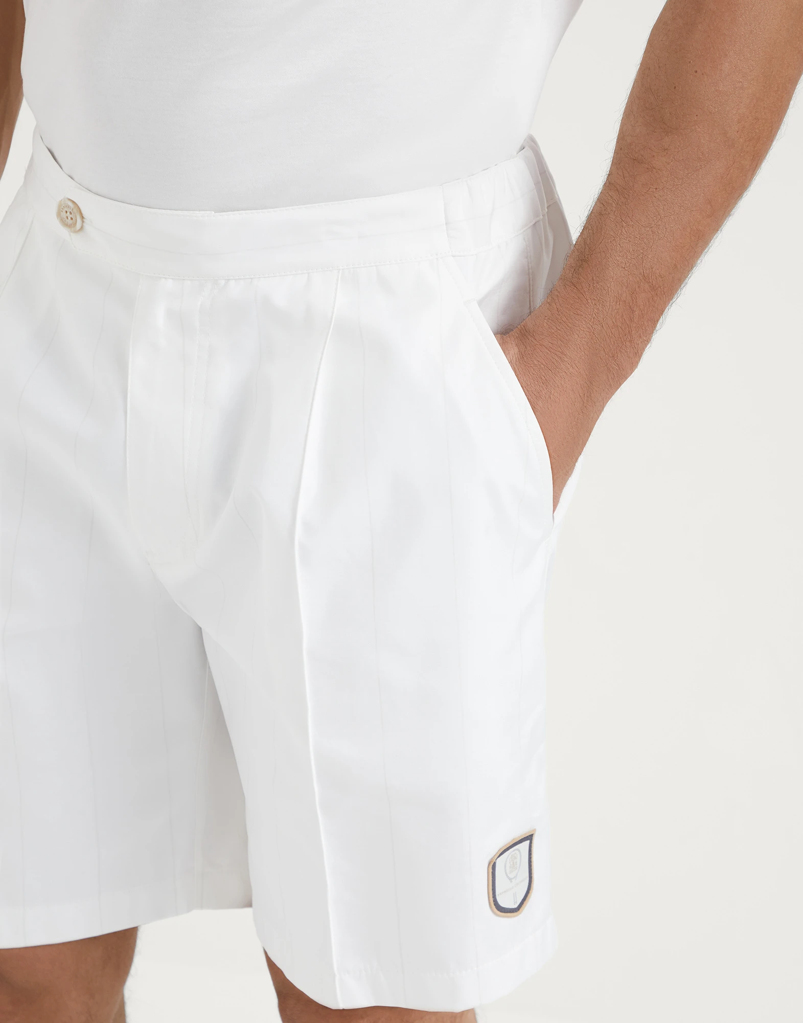 Chalk stripe nylon pleated Bermuda shorts with tabbed waistband and tennis badge