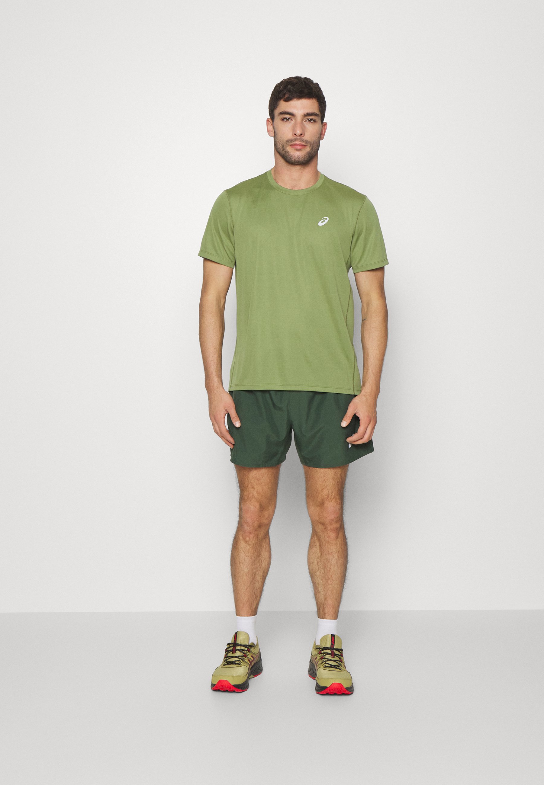 ASICS CORE - Sports shorts - rain forest/dark green
