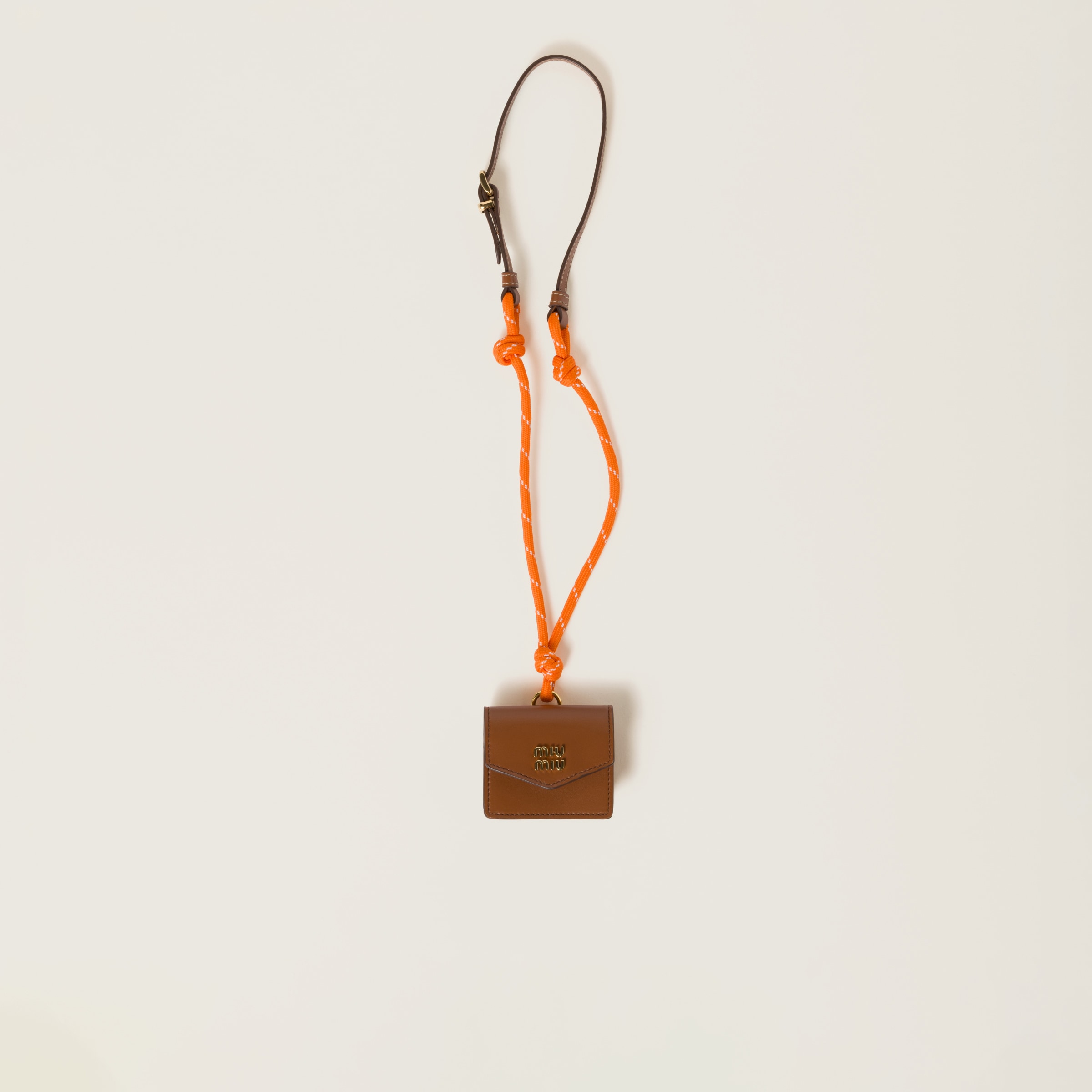 Leather, cord, and metal trick with mini-pouch