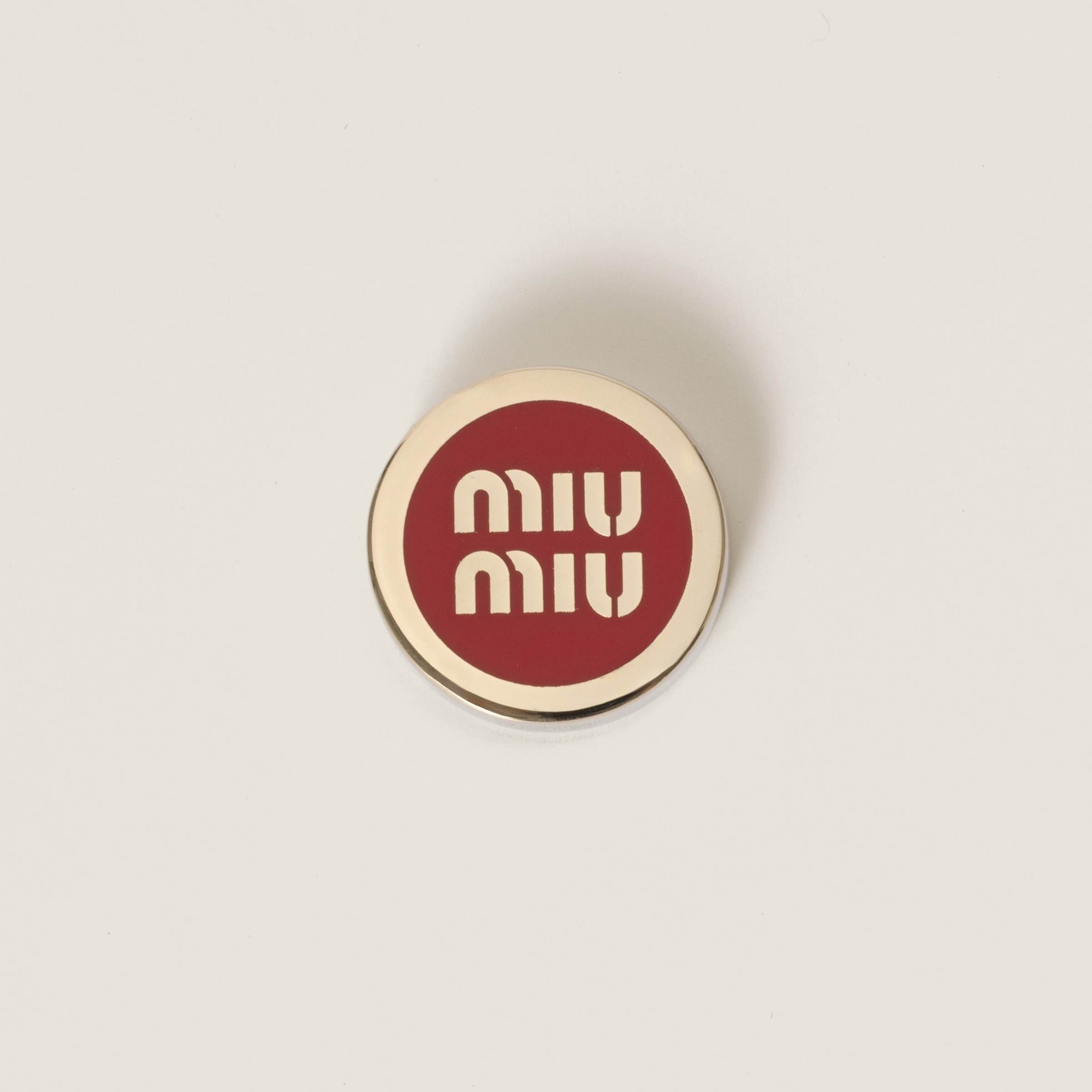 Enameled metal logo brooch