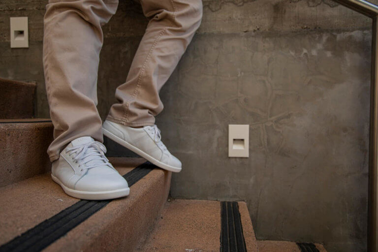 A man standing casually on the stairs in his Dillon Leather shoes