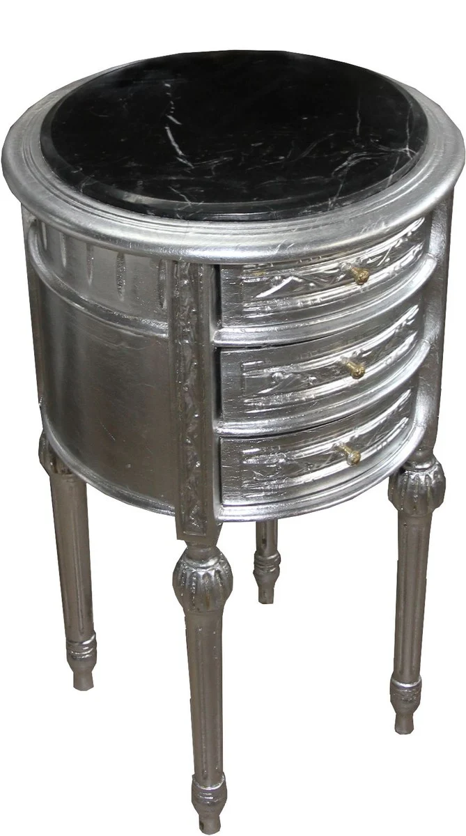 Cajonera barroca Casa Padrino / mesa auxiliar plateada con tapa de mármol negro Altura 72 cm, diámetro 41 cm - consola de mesita de noche