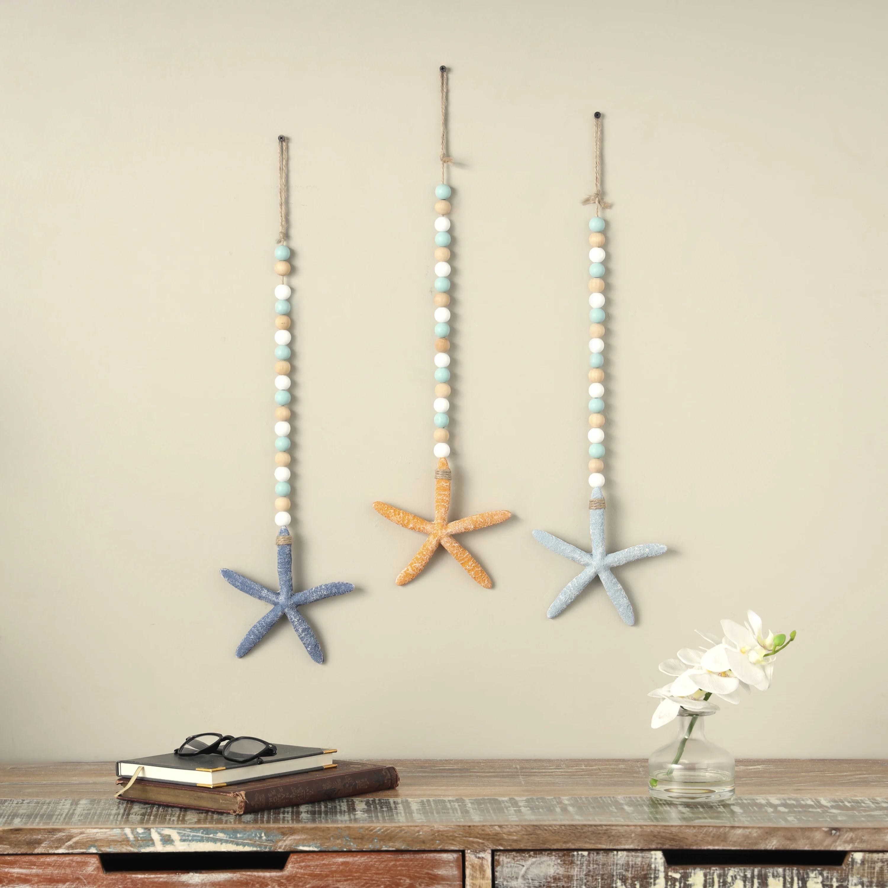 DecMode Blue Wood Handmade Textured Starfish Wall Decor with Long Beaded Hanging Rope (3 Count)