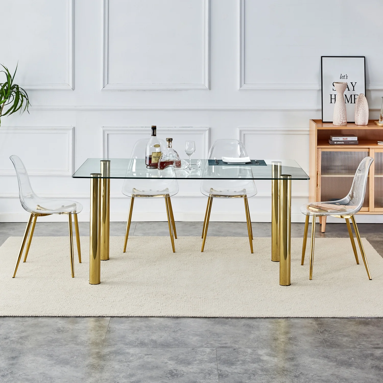 Upgrade your Dining Room with Luxurious T-003 TW-1200 4-Piece Dining Set featurning Crystal Clear Tempered Glass Tabletop and Gold-Plated Metal Legs. This set includes Modern Armless Chai