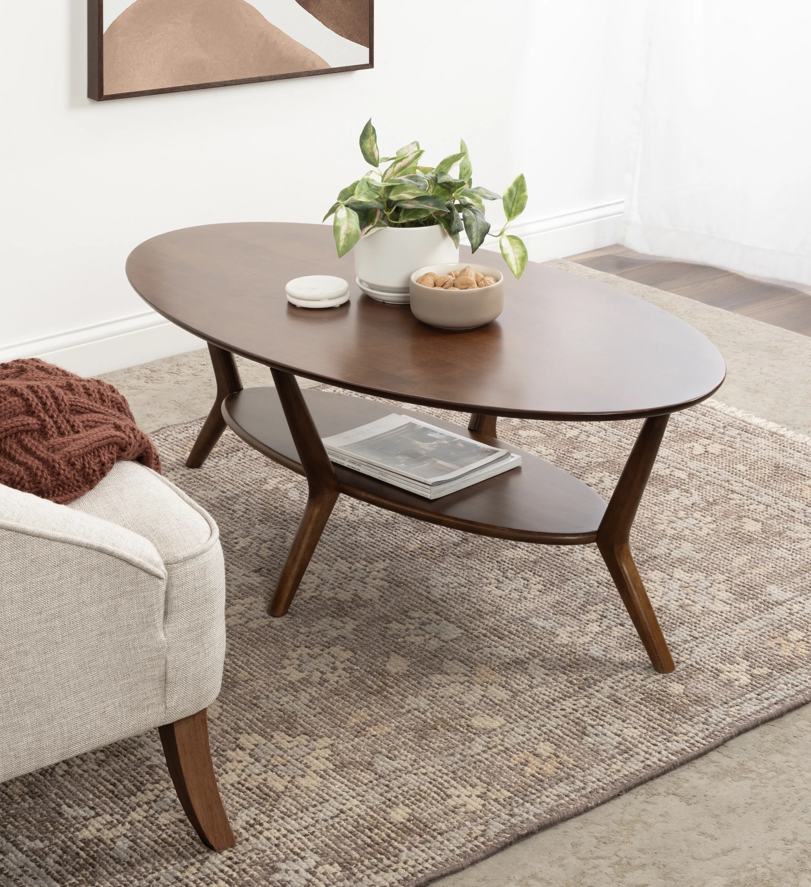 Kate and Laurel Nylah Oval Wooden Coffee Table, 48 x 26 x 18, Walnut Brown, Mid-Century Tiered Living Room Table with Solid Wood Construction and Sculptured Dowel Legs