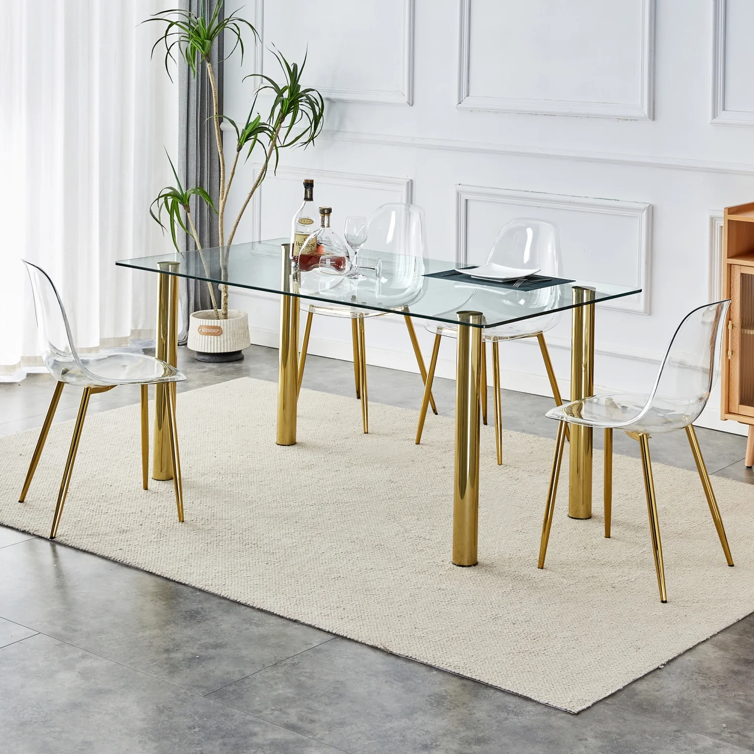 Upgrade your Dining Room with Luxurious T-003 TW-1200 4-Piece Dining Set featurning Crystal Clear Tempered Glass Tabletop and Gold-Plated Metal Legs. This set includes Modern Armless Chai