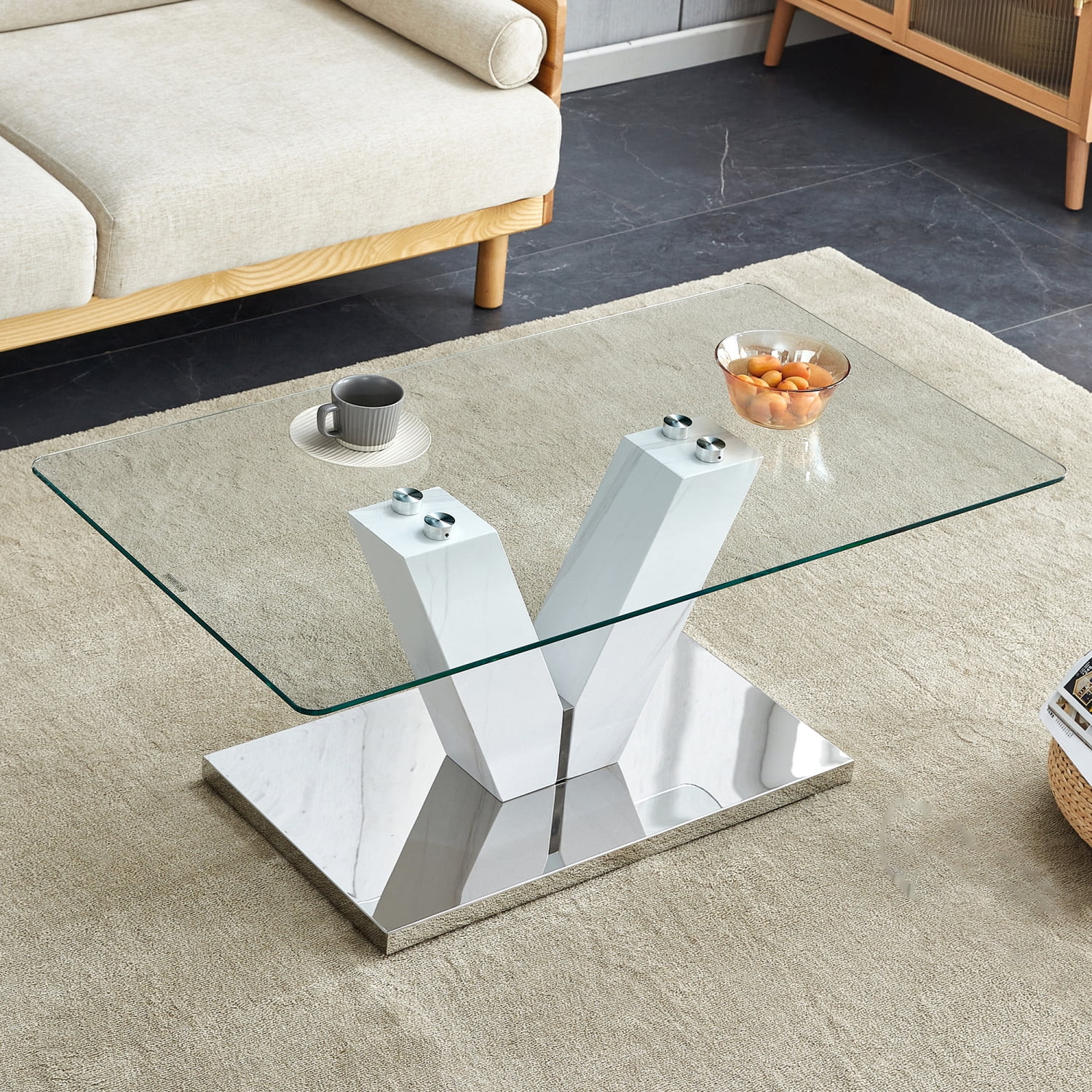 Sleek and contemporary modern coffee table featuring minimalist design. Clear tempered glass tabletop rests elegantly on sleek silver MDF pillars. Perfect addition to any modern living ro
