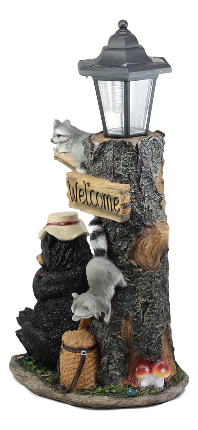Ebros Summer Naps Whimsical Forest Lazy Bear With Raccoon Friends Welcome Sign Outpost Statue With Solar LED Light Lantern