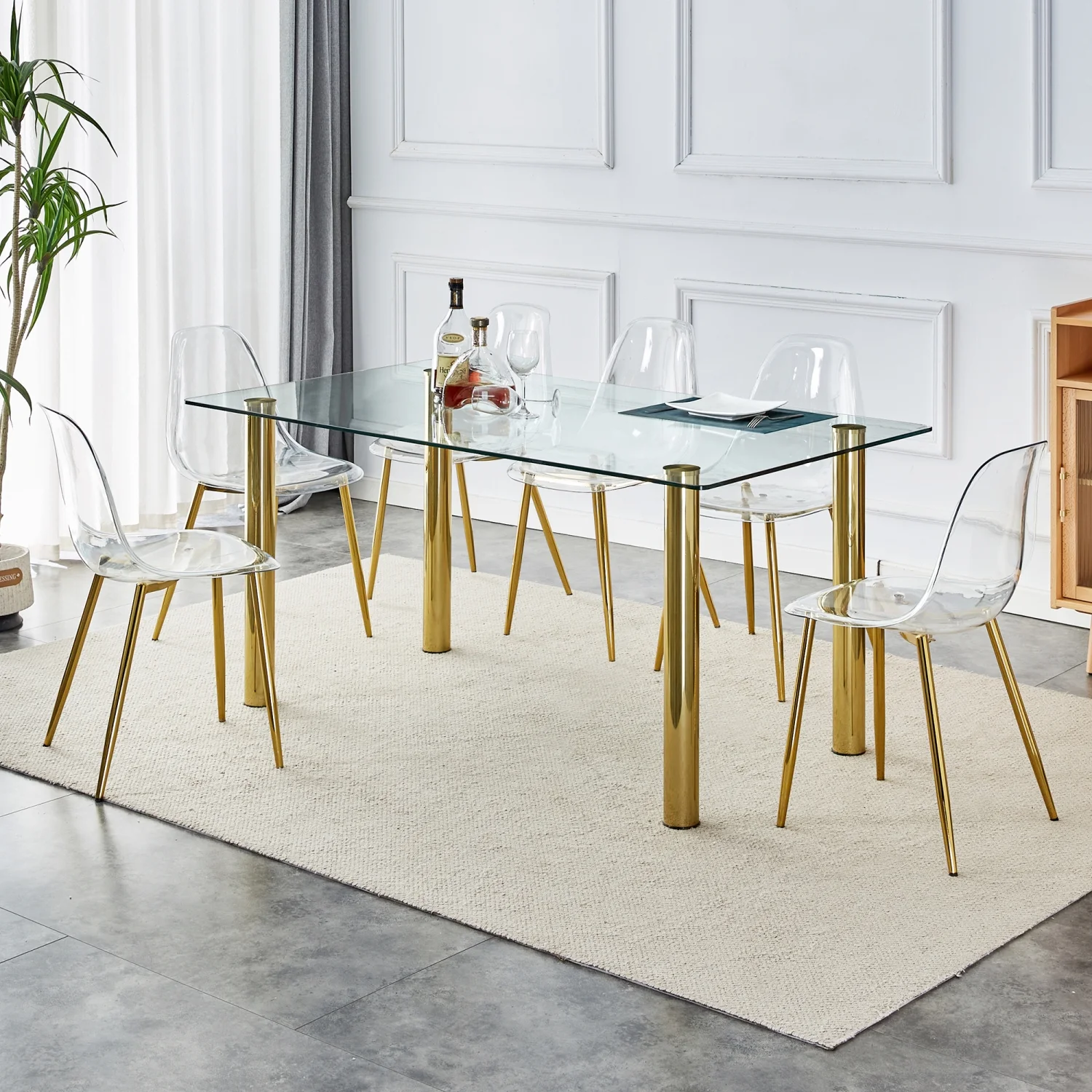 Upgrade your Dining Room with Luxurious T-003 TW-1200 4-Piece Dining Set featurning Crystal Clear Tempered Glass Tabletop and Gold-Plated Metal Legs. This set includes Modern Armless Chai