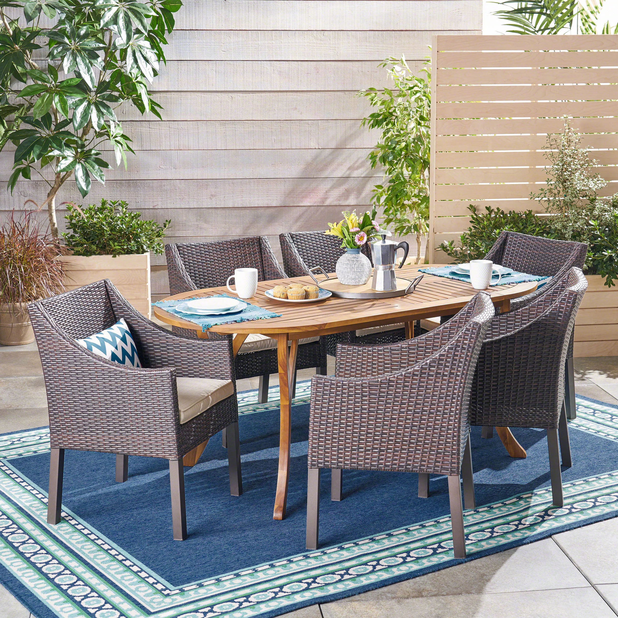 GDF Studio Llano Outdoor Acacia Wood and Wicker 7 Piece Dining Set with Cushions, Teak, Multibrown, and Cream