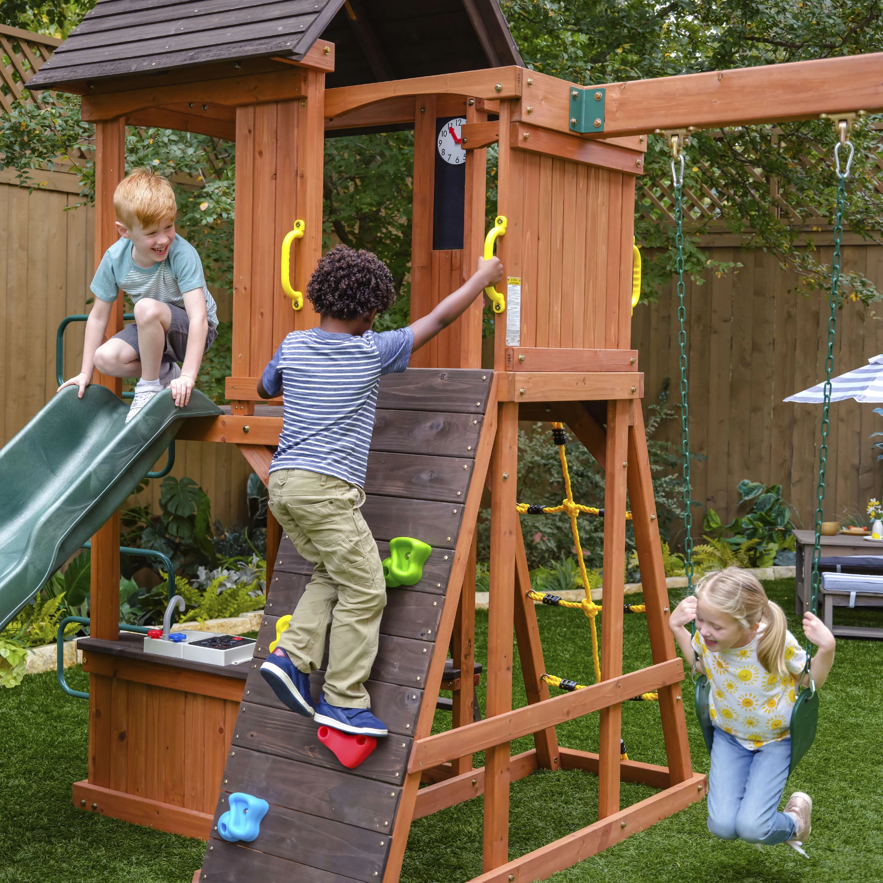 KidKraft Raptor Trail Wooden Outdoor Swing Set with Wavy Slide and Rock Wall, For Ages 3-10