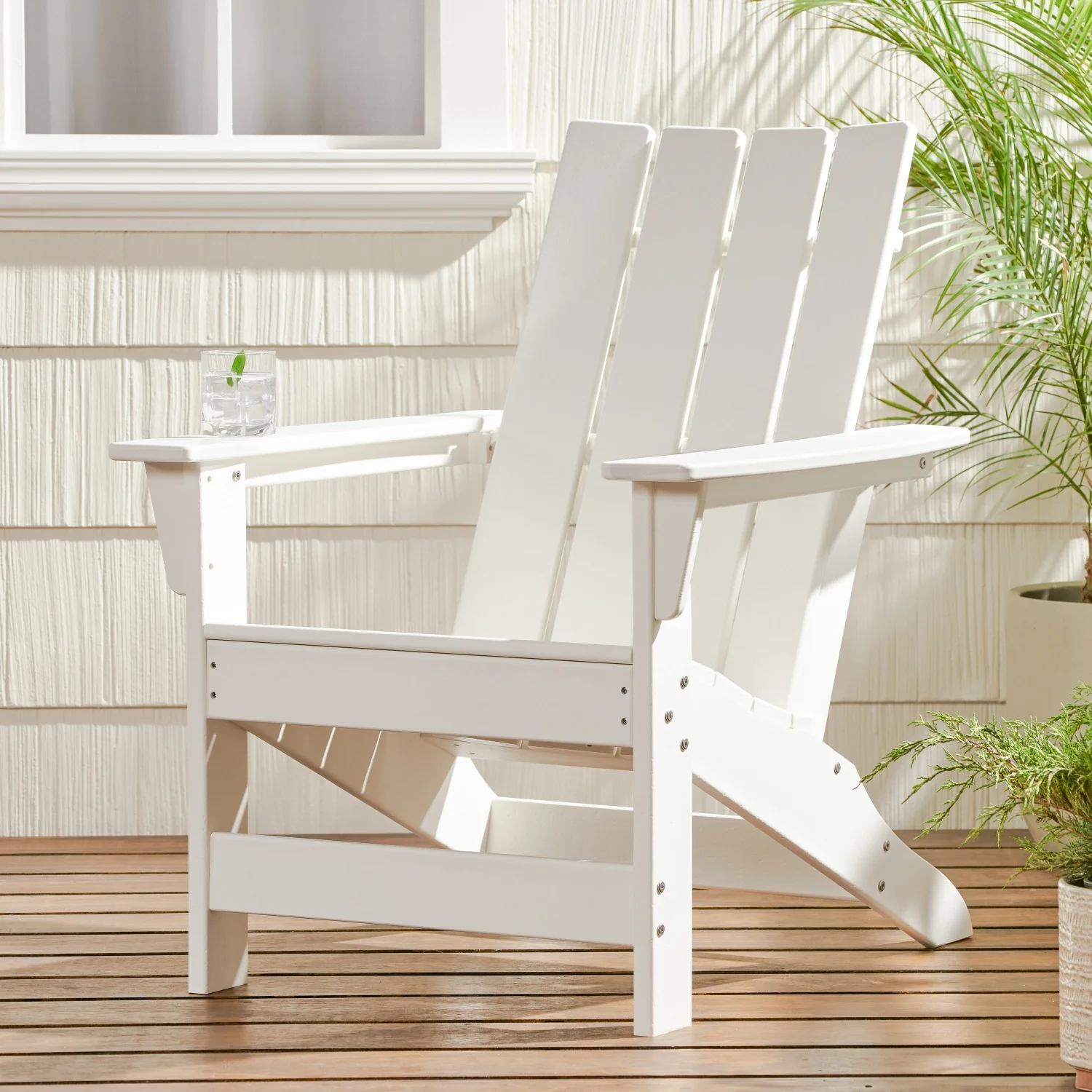 Experience Ultimate Comfort and Style with the Stylish and Comfortable Encino Adirondack Chair - The Perfect Choice for Relaxing Outdoors on Summer Days in Your Backyard.