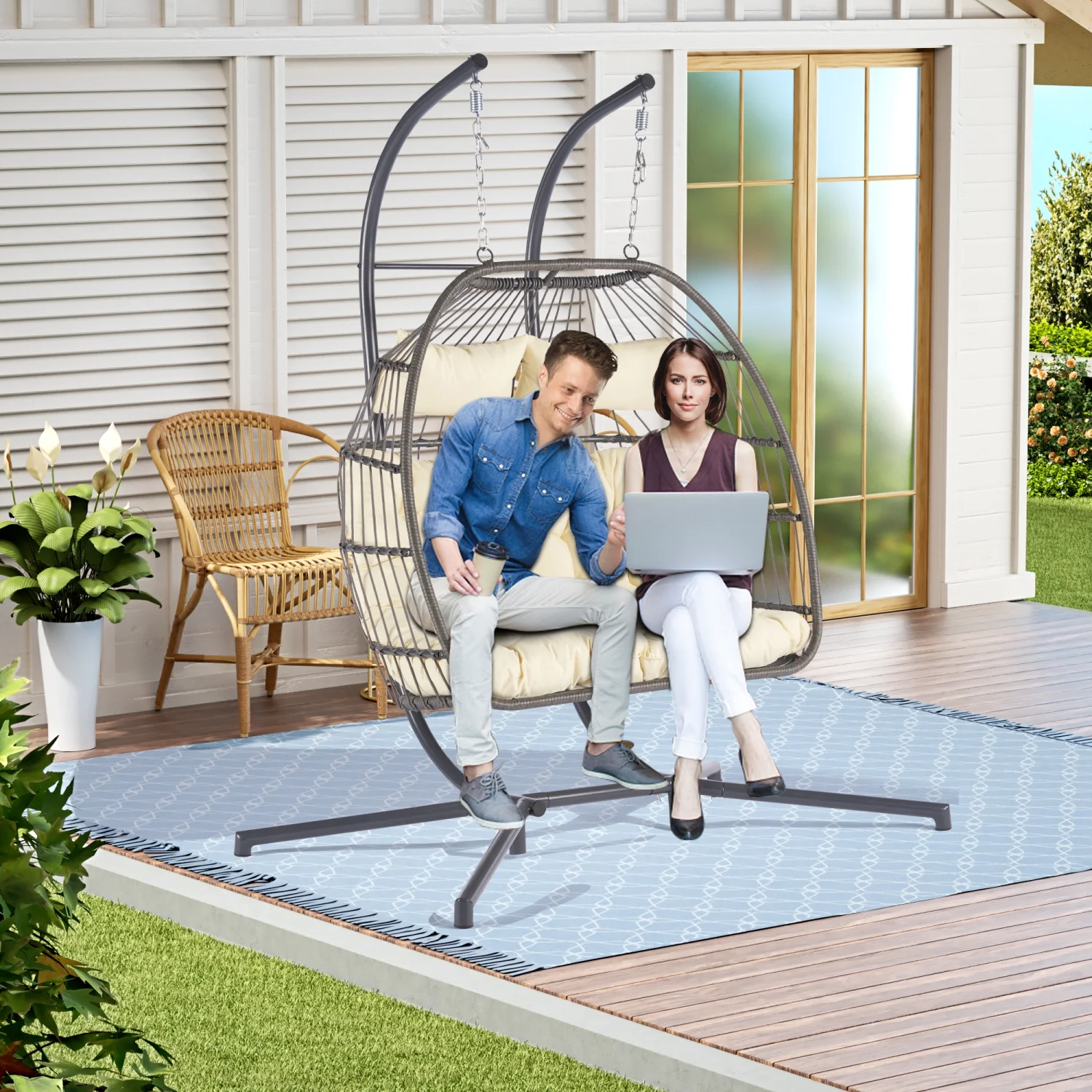 Stylish and comfortable outdoor patio wicker egg chair with cushion - perfect addition to your garden or outdoor space for relaxing in the sun. Enjoy this 2 person rattan hanging chair in